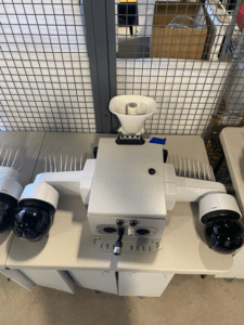 A white machine with two cameras on top of it.