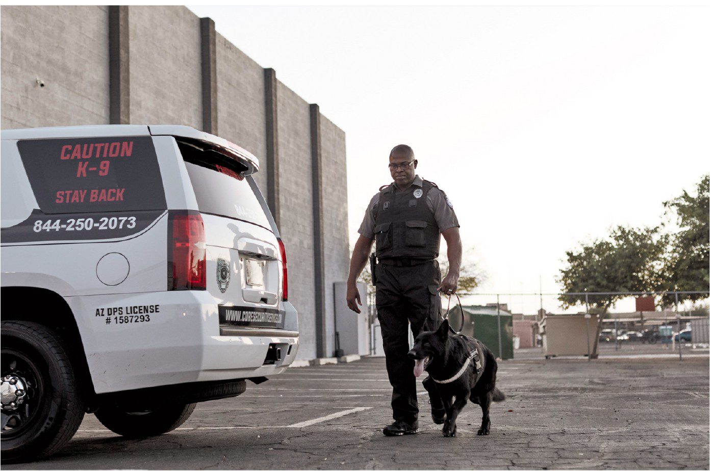 Police officer walking K-9 dog.
